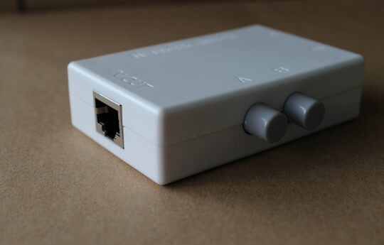 Rj45 two-port network switch sharing device inside and outside