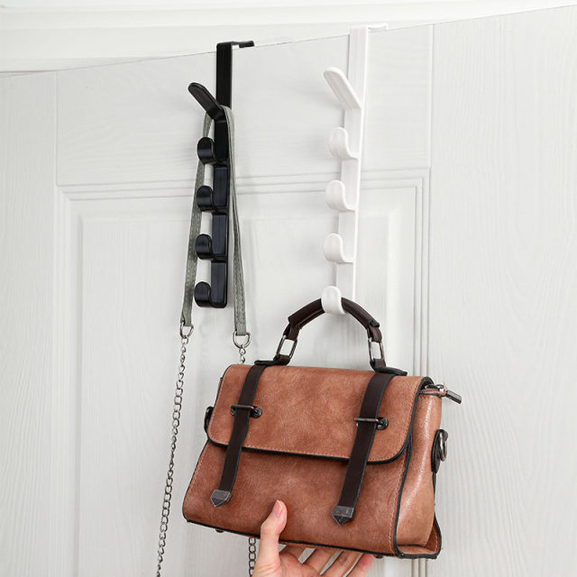 Long row of hooks behind the door bags and racks ins dormitory collection