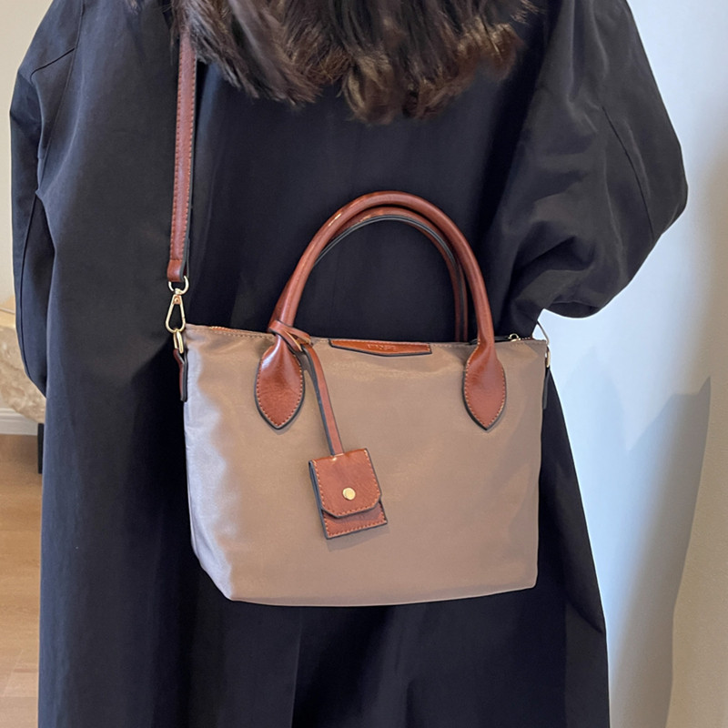 大容量上班通勤托特包包女士2025新款休闲斜挎大包手提牛津帆布包,淘宝优惠券,粉丝福利购,淘宝优惠卷