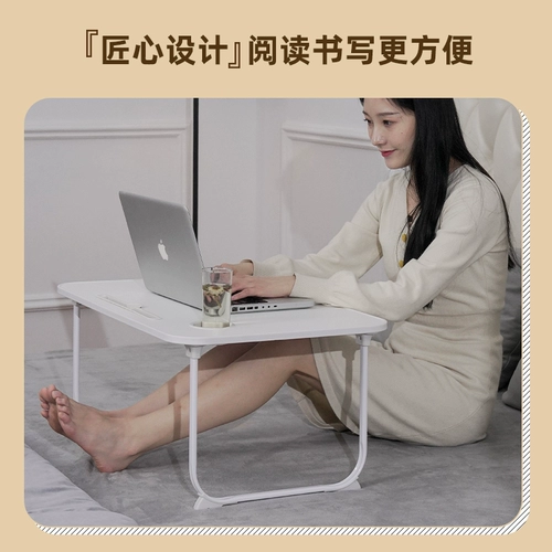 Небольшой стол на кровати, складной столик для складного стола в бурном окне.