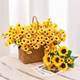 Sunflower arrangement, hand holding bouquet on floor table