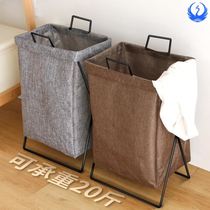 Bedroom with clothes on the bedside bedside bedside bed tail containing the dirty laundry basket of the clothes for the temporary discharge of the clothes