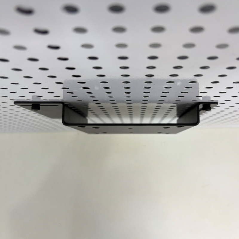 Perforated board computer screen stand saves space