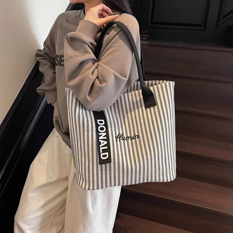 2025年春季女包大容量新款潮流单肩包简约手提休闲包撞色托特包女,淘宝优惠券,粉丝福利购,淘宝优惠卷