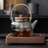 Light luxury walnut electric ceramic stove, heat-resistant glass lifting beam kettle, tea making set around the stove