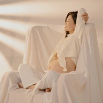 The new pregnant woman takes a photo of the clothes a small fresher art photo of a true white meritocratic and windy photo of a pregnant woman taking pictures of clothes