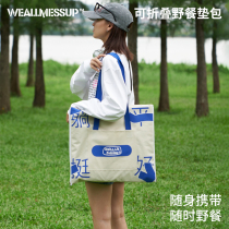 Clutter and clueless lying flat on a series of satchel picnic cushions folded to contain moisture and waterproof mat outskirts.