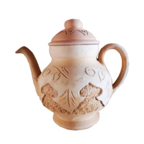 Traditional Handmade Earth Pottery Indoor Decoration Pendulum with white pottery teapot in the ancient city of Kashgar in Xinjiang Uygur Autonomous Region