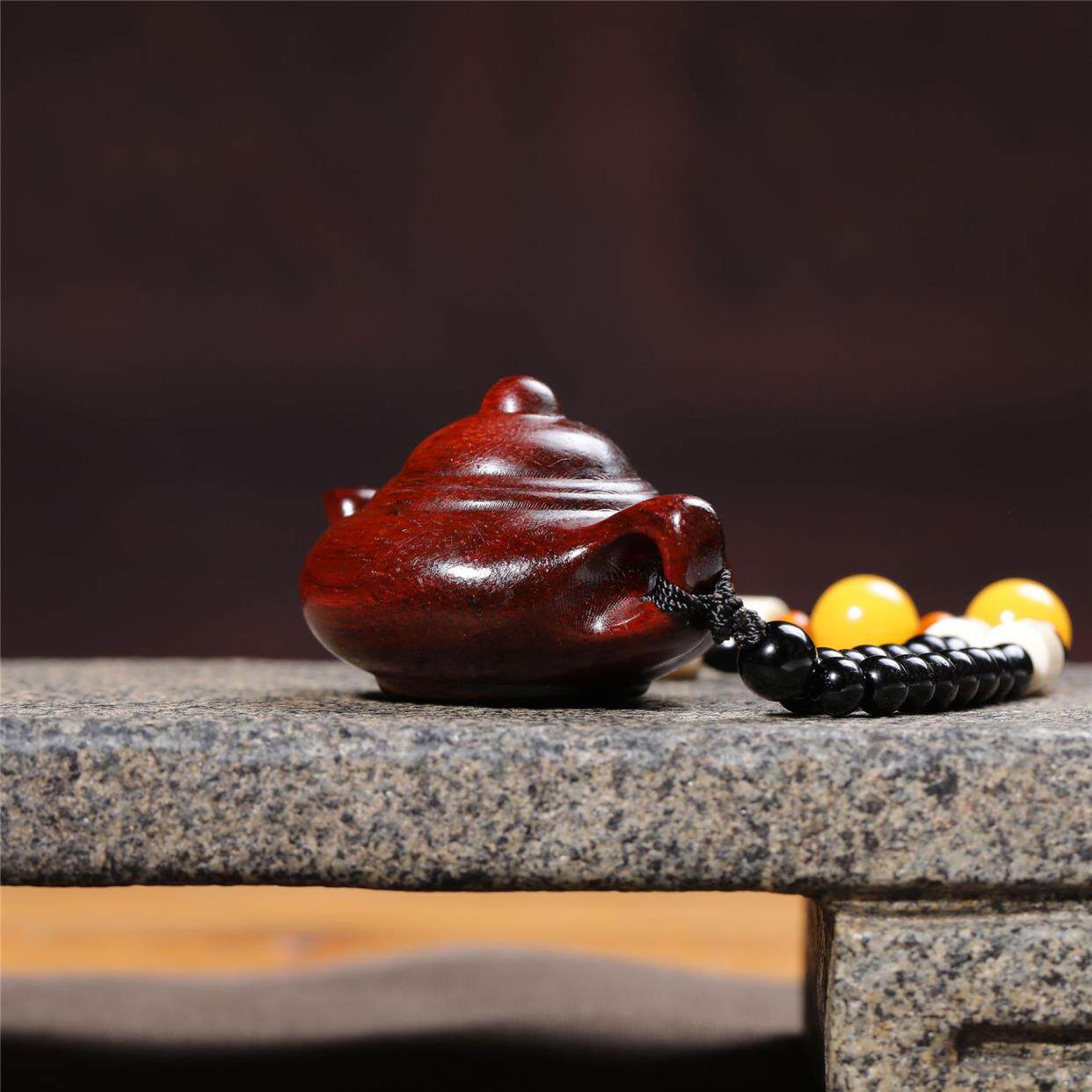 Hand-carved teapot made of rosewood