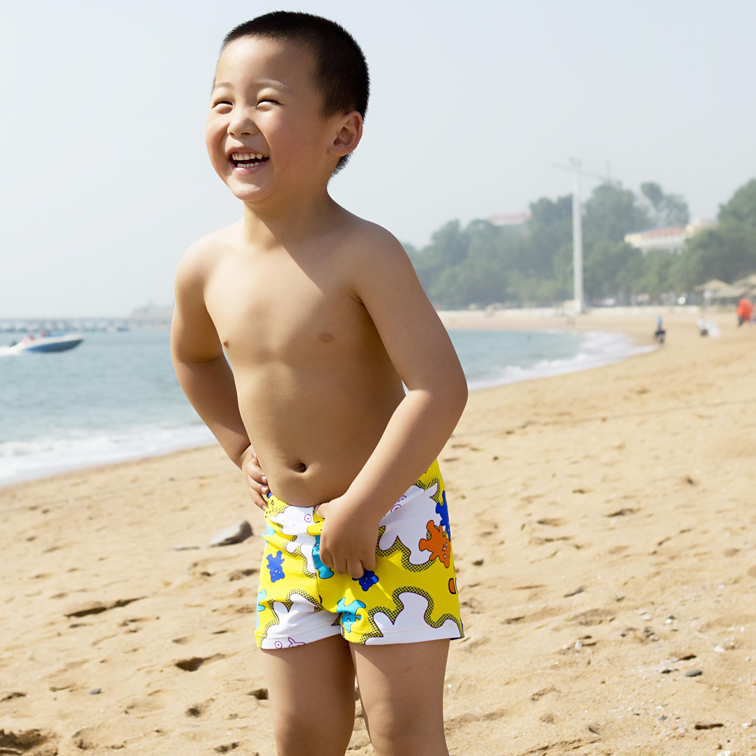little boy in swim trunks