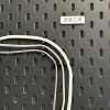 Cable organizer bracket adapts to IKEA perforated plate
