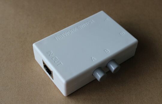 Rj45 two-port network switch sharing device inside and outside