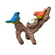 Simulated branch birdbath hanging ornaments on the side of the tank