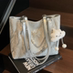 High-end one-shoulder niche design bag for women summer 2026 new style fashionable and versatile large-capacity commuter tote bag
