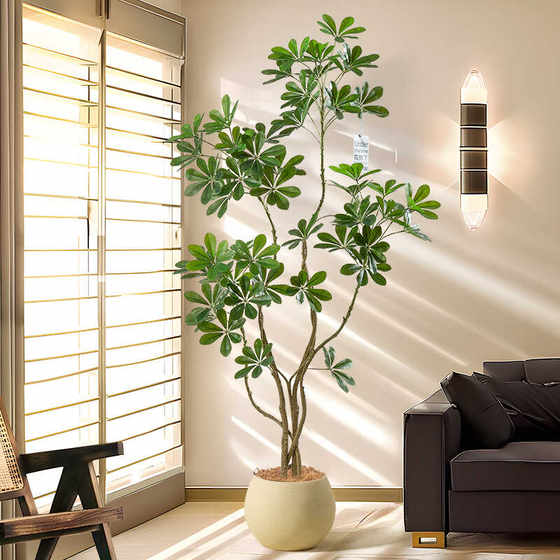 Decoration floor-standing potted plant indoor fake tree next to the sofa in the living room
