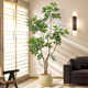 Decoration floor-standing potted plant indoor fake tree next to the sofa in the living room