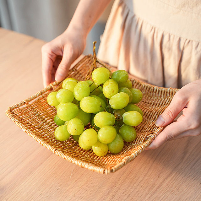It is a plastic Japanese square snack plate with dessert melon seeds