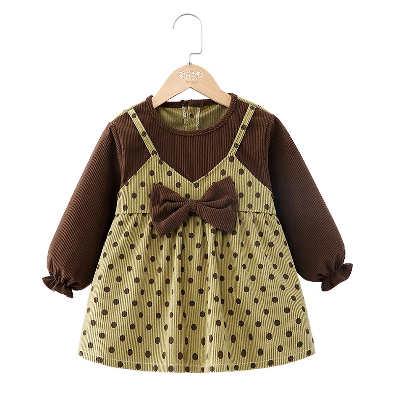 Baby girl wears princess skirt and bib outside eating blouse