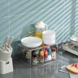 Комбинированный стол на кухне представляет собой приправные бутылочные мусоры, хранилище многофункциональные прозрачные канцелярские канцелярские товары.