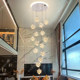 Long chandelier in the spiral staircase of duplex villa