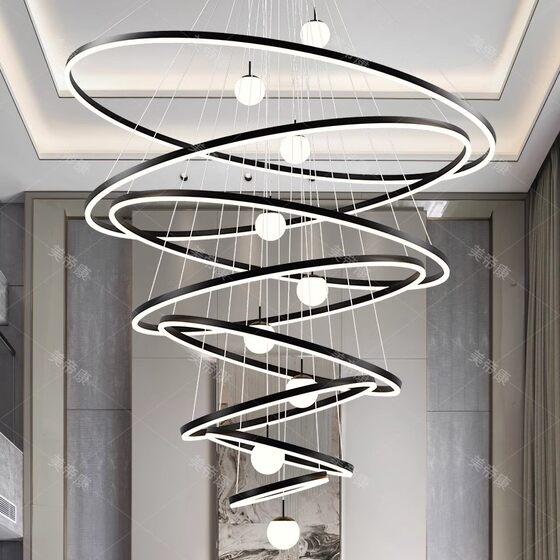 Duplex building with large chandelier in empty living room villa