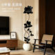 Simulated green plants and black diamond next to the TV cabinet in the indoor living room