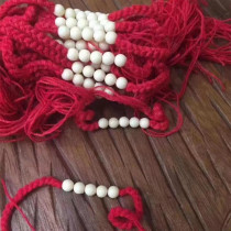 Tedwatu man with a little red rope with a small red rope.