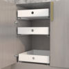 All-white kitchen cabinets with deep cabinets remodeled with basket drawers