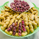 Four red boiled salted dried peanuts as a snack