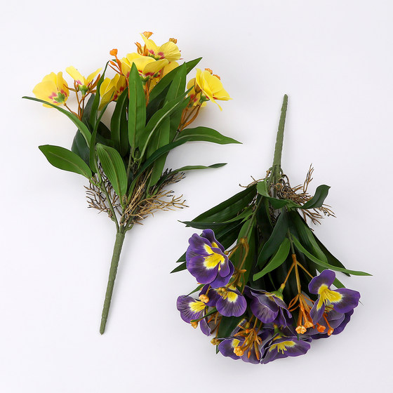 Simulated artificial flowers and green plants decorative leaves and begonia flowers