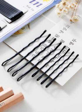 Black straight hair clip with spray-painted edges, used for
