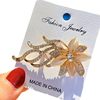 Korean high-end fashion rhinestone cat's eye orchid brooch corsage collar pin versatile clothing accessories scarf buckle wholesale
