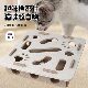 Pet cat digs a hole in the felt box to amuse the cat with a bell ball