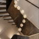 Long chandelier in the spiral staircase of duplex villa