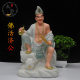 The resin statue of Jigong is enshrined in white marble