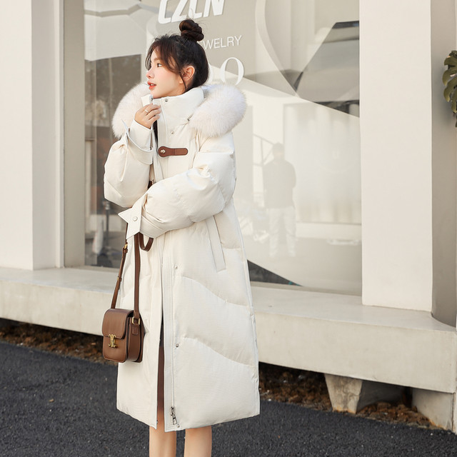 Fox fur collar long down jacket flying in the snow hooded