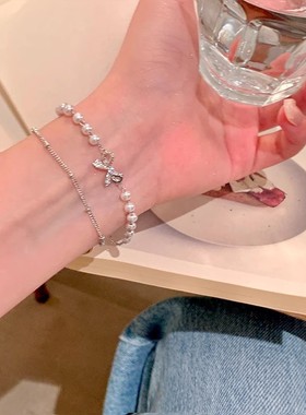 搜搜新款双层叠戴蝴蝶结手链女轻奢小众高级感珍珠手串手饰批发