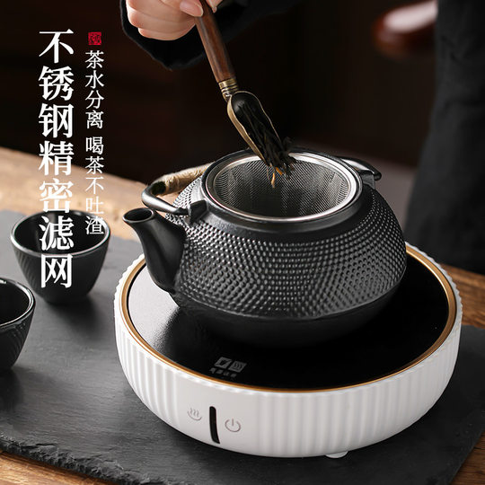 Cast iron teapot set tea set around the stove to make tea and kettle