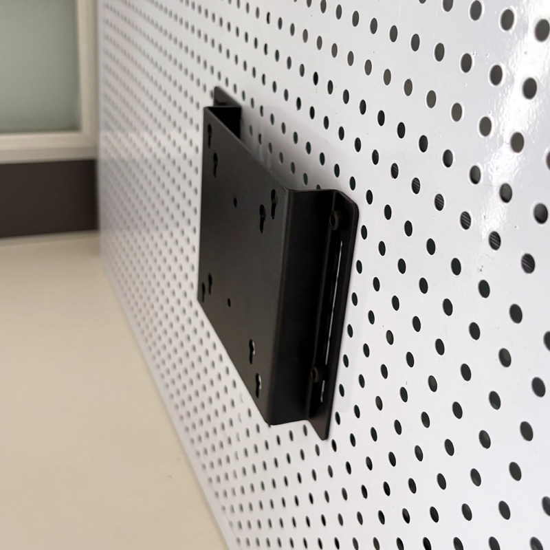 Perforated board computer screen stand saves space