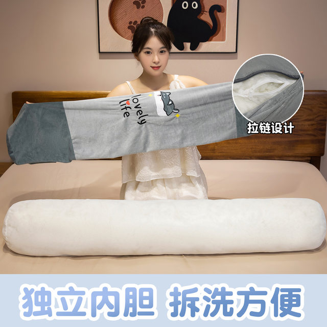 Bibi is a big doll sleeping on the bed with pillows