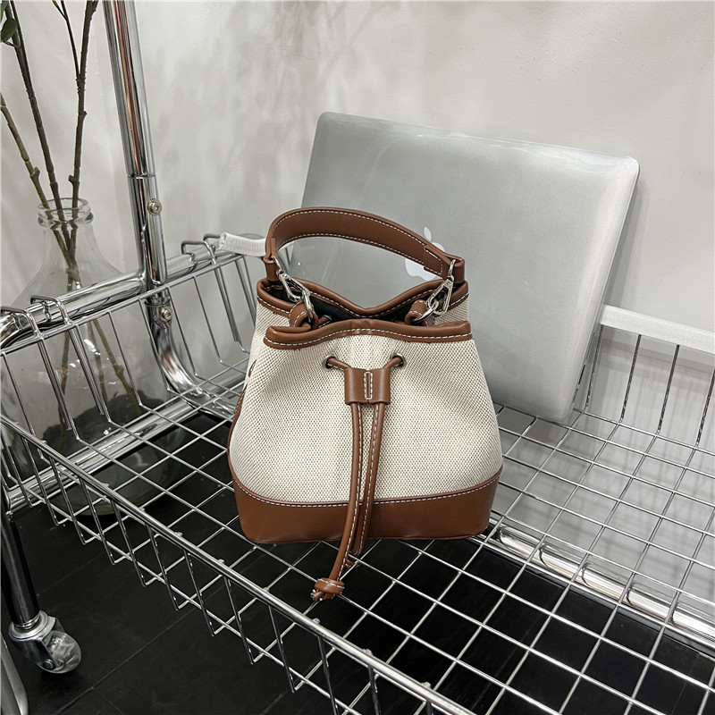 小脏柜 拼接帆布质感抽绳水桶包时尚精致撞色手提包包韩系斜挎包,淘宝优惠券,粉丝福利购,淘宝优惠卷