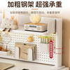 Multi-layer perforated board bookshelf on home computer desk
