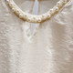 2025 ຮູບແບບຝຣັ່ງໃຫມ່ 2025 Round Neck Beaded Hollow Solid Color Pullover Long Sleeve Shirt Women's Autumn Thin Top