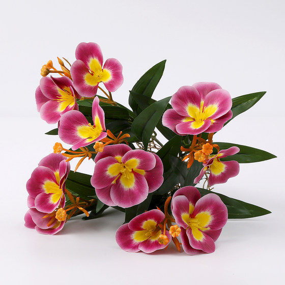 Simulated artificial flowers and green plants decorative leaves and begonia flowers