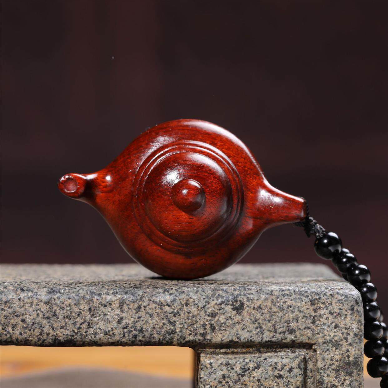 Hand-carved teapot made of rosewood