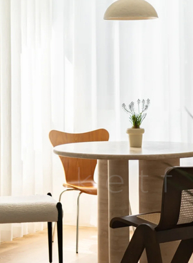 北欧简约侘寂风洞石餐桌设计师款小户型天然大理石吃饭桌圆桌子