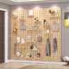 See details for storage on solid wood hole board. Wall rack for living room. Hanging partition for storage. Wall rack with background wall background. Simple wooden book.