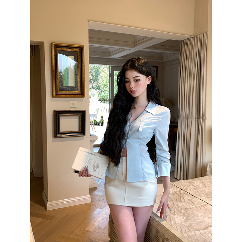 A spring-style, sexy, slim-fitting, V-neck, waist-cinching shirt for women.