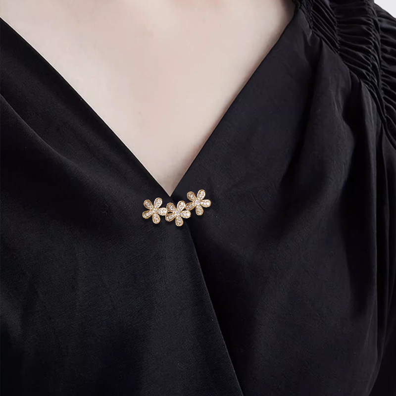 A delicate flower-shaped brooch to secure a simple shirt, preventing wardrobe malfunctions and adding a touch of unique design to the collar.
