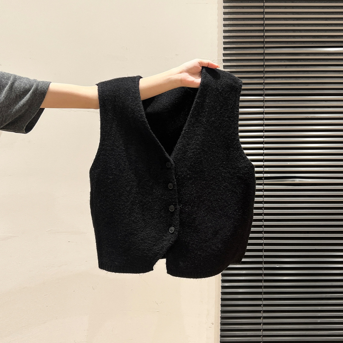 Black V-neck knitted cardigan vest for women, suitable for autumn and winter 2026. Versatile and layerable.